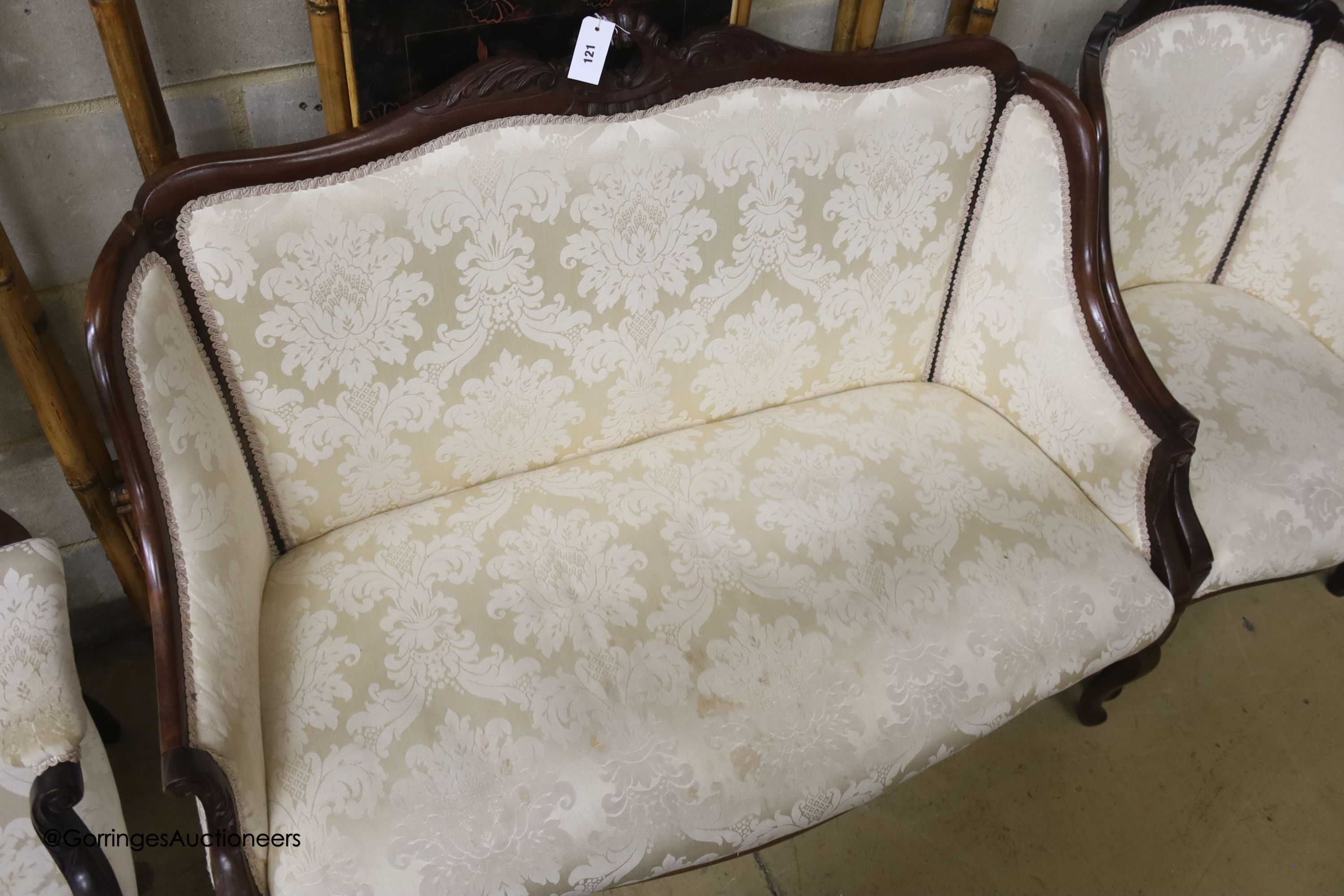 A late Victorian mahogany three piece salon suite